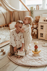 soft stripes brown organic babymat, children are playing together on the mat, wooden toys, mouse cuddle in bed