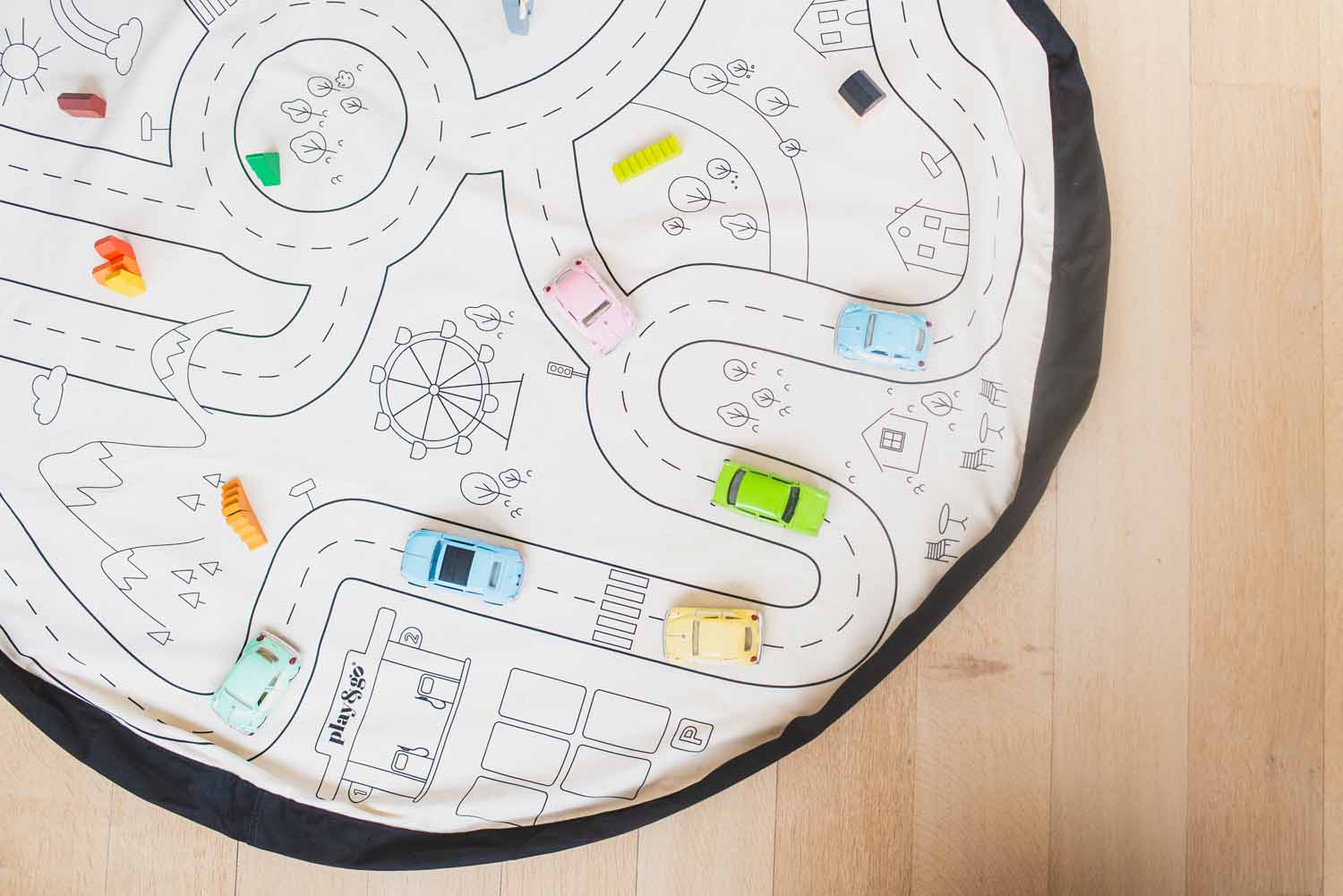 playville toy storage bag, open on floor with wooden toy cars, roadmap