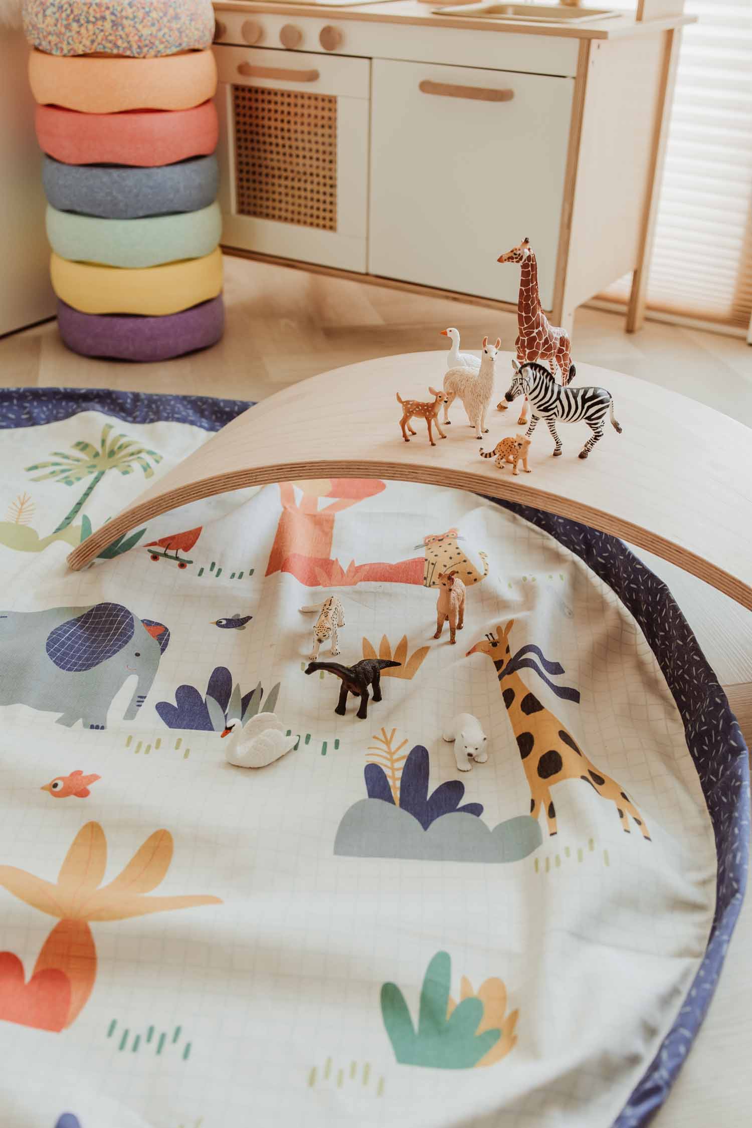 toy storage bag, Toupitis, Play&Go, Moulin Roty, open mat with many animal toys on wooden bridge