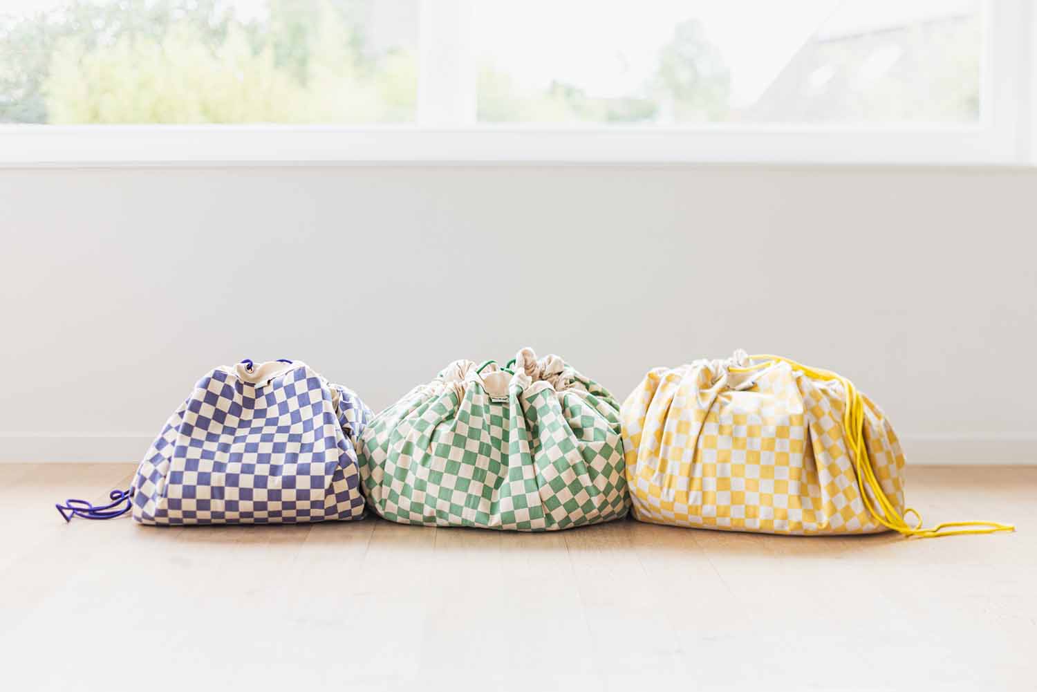 vichy storage bags, all colors, closed, on the floor next to each other