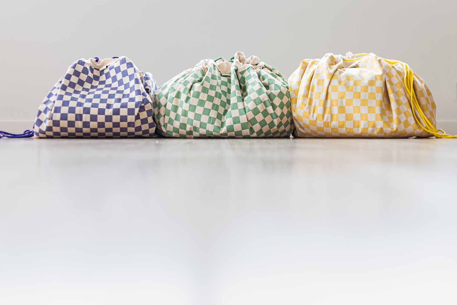 vichy toy storage bags, closed on floor, put next to each other