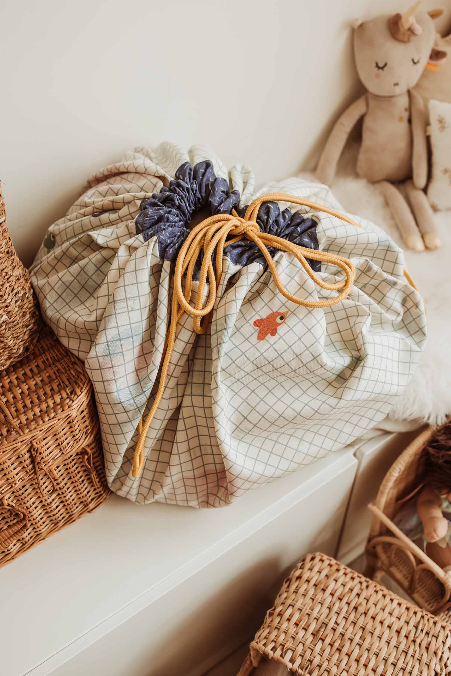 toy storage bag, Toupitis, Play&Go, Moulin Roty, closed bag next to wooden baskets and cuddle