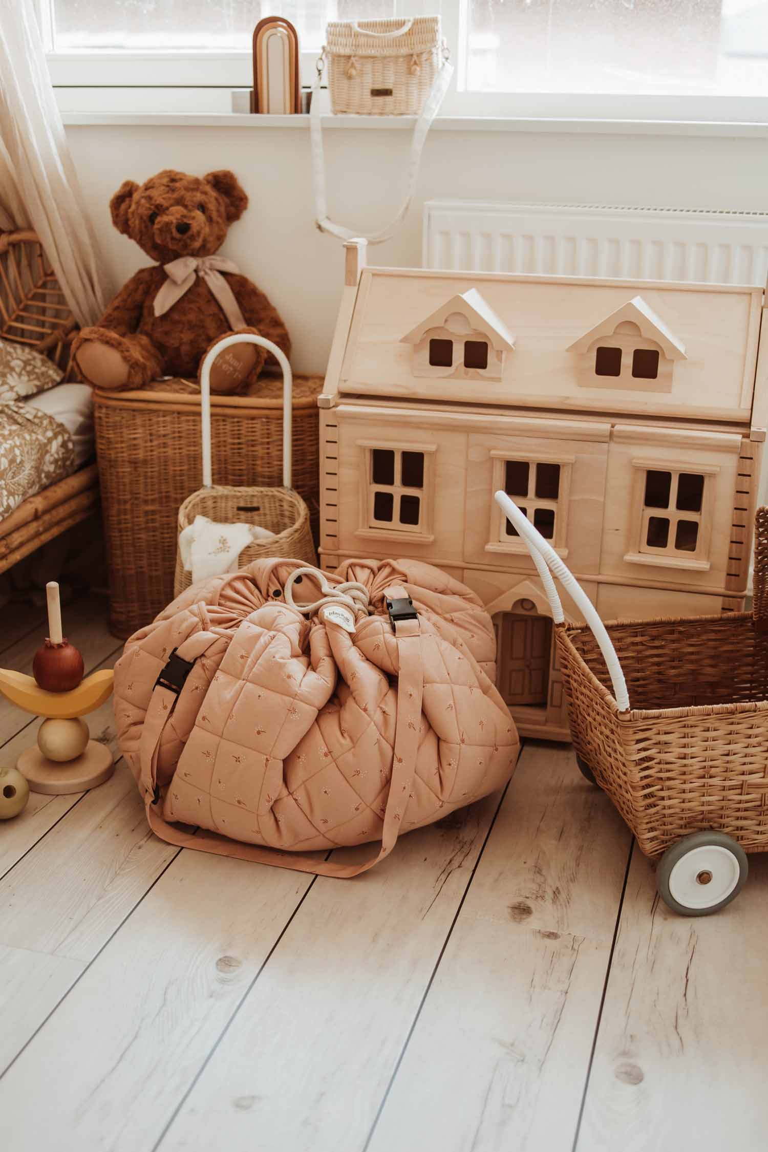 Fleuri organic babymat, closed bag on floor in kidsroom next to victorian house and stroller, cuddle on top of basket