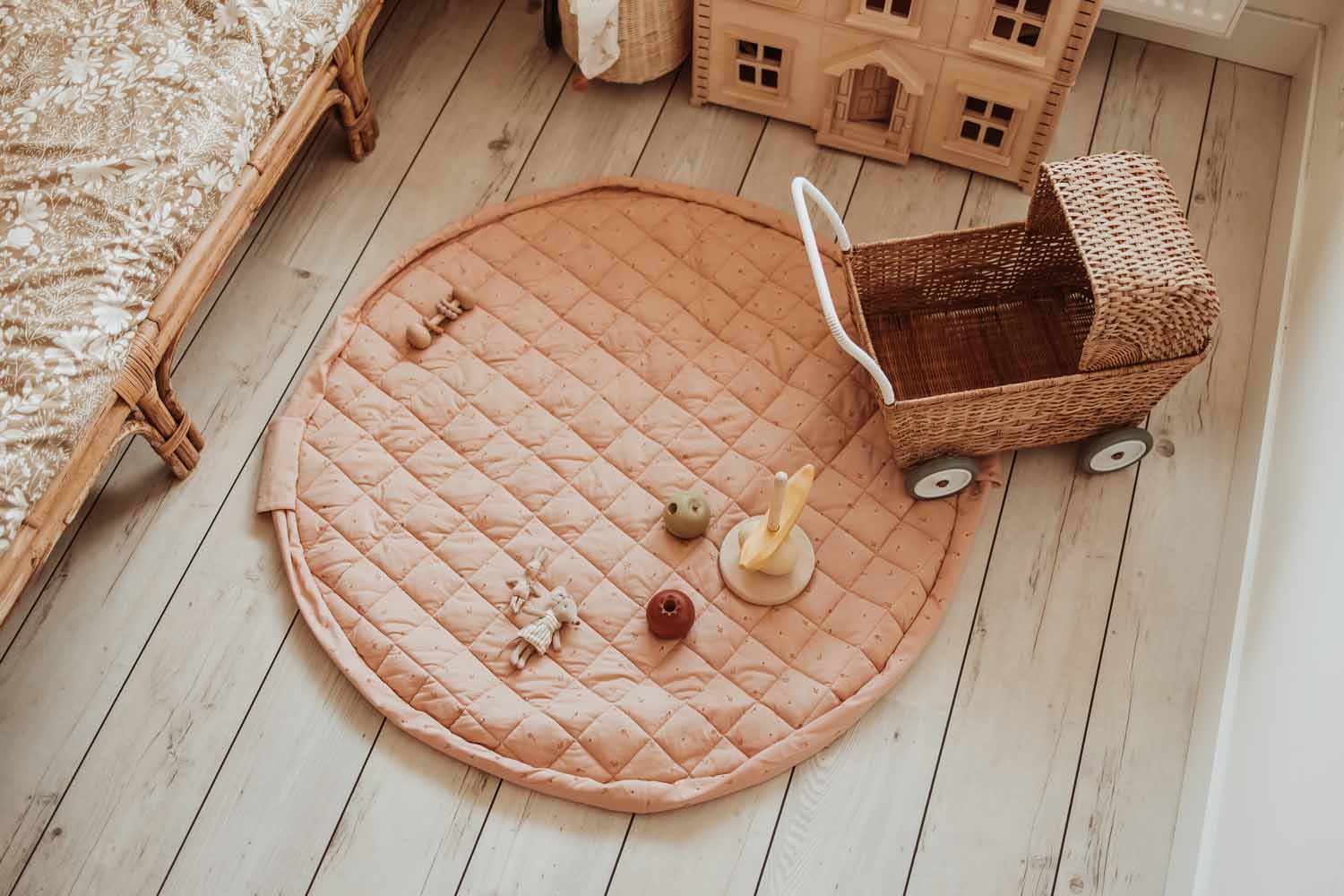 Fleuri organic babymat, open on floor in kidsroom, stroller, victorian playhouse and bed