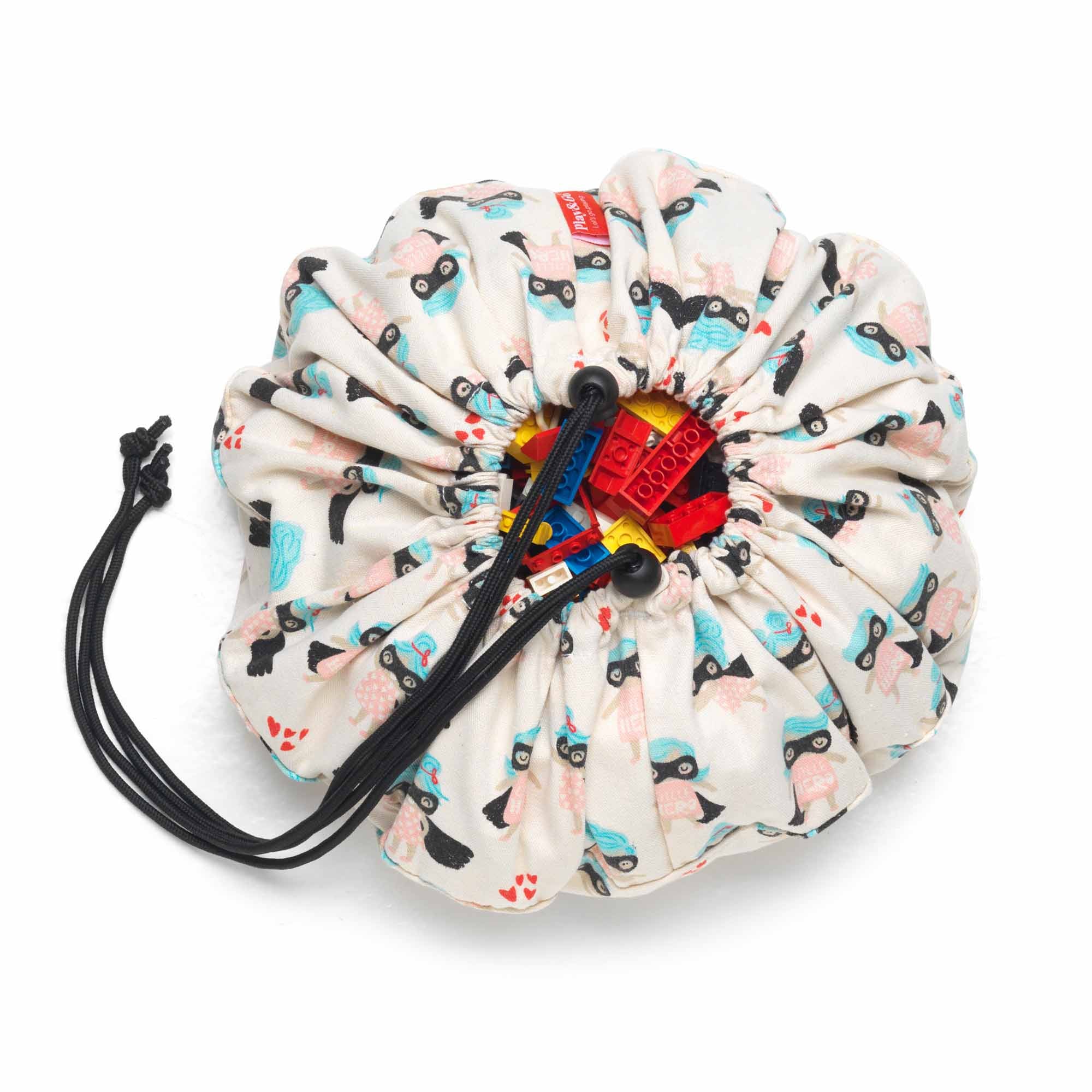 supergirl mini toy storage bag, filled with lego