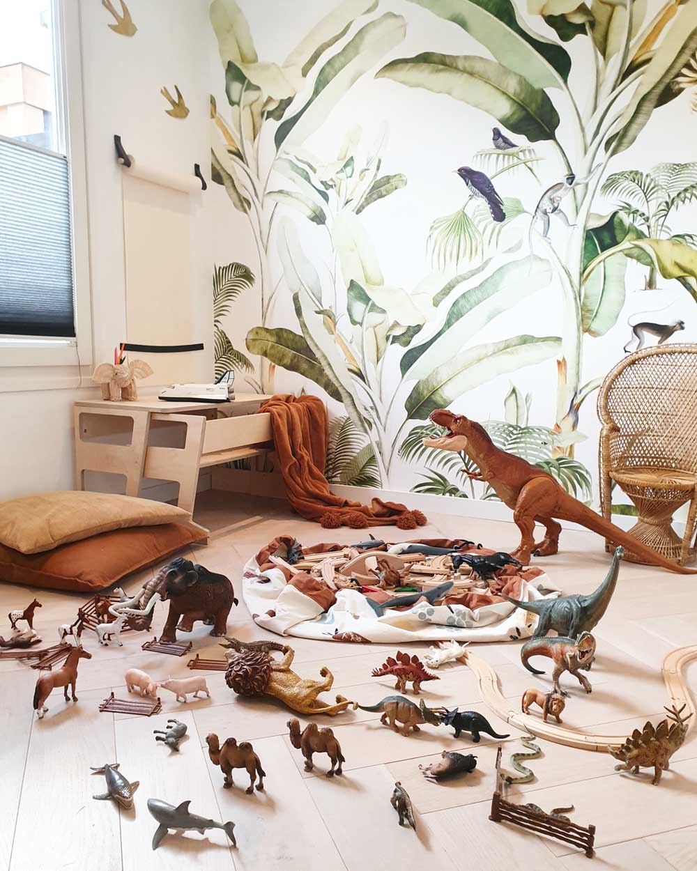 veggie numbers storage bag, open of floor, jungle wall paper, lots of animal toys, pillows, desk and chair in room