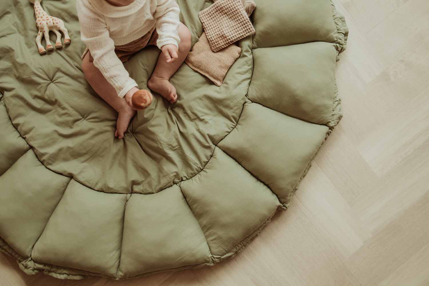 meadow green organic baby mat, baby sitting on mat, playing 