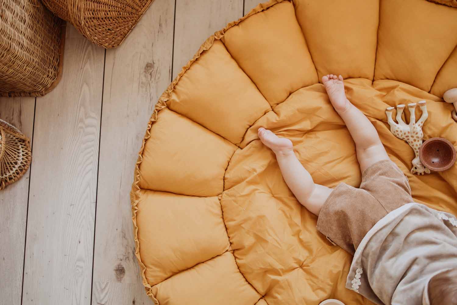 Bloom mustard organic babymat, detail picture, open mat, baby lying on mat, cuddle Sophie la Giraffe