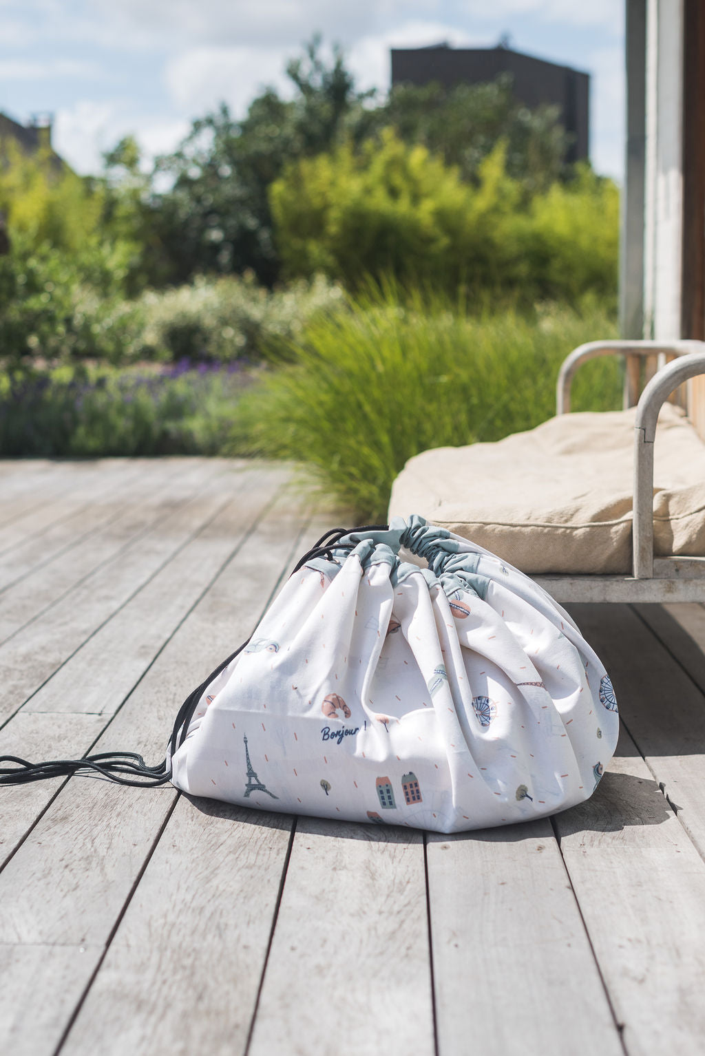 stylish designed Paris Map toy storage bag, closed bag outside on the terrace