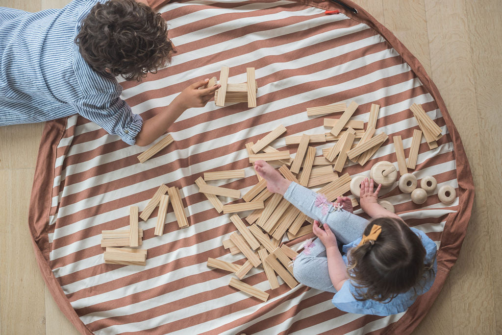 Stripes brown toy storage bag and play mat, children playing with wooden blocks