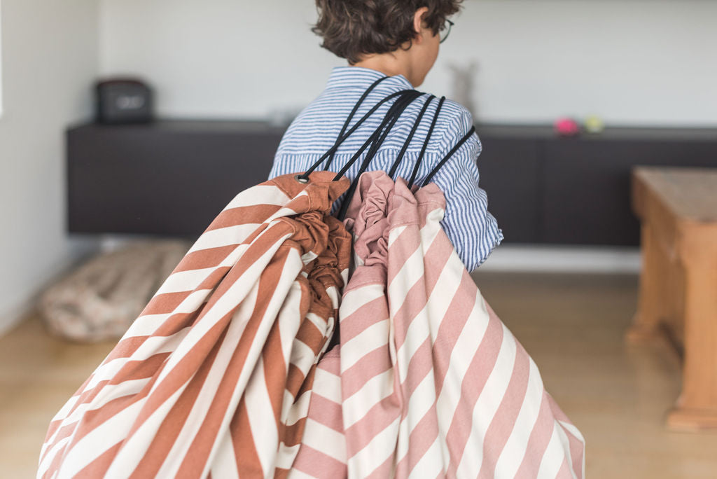 Stripes Pink New toy storage bag, child carrying a Stripes Pink New and a Stripes Brown bag
