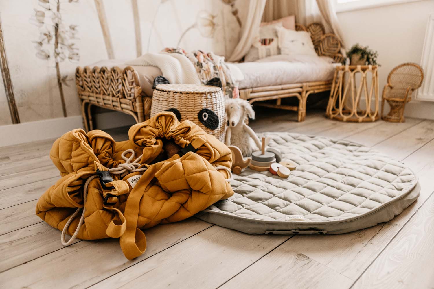 Meadow Green soft padded baby play mat, mat on floor next to Chai Tea bag, kidsroom with bed in corner