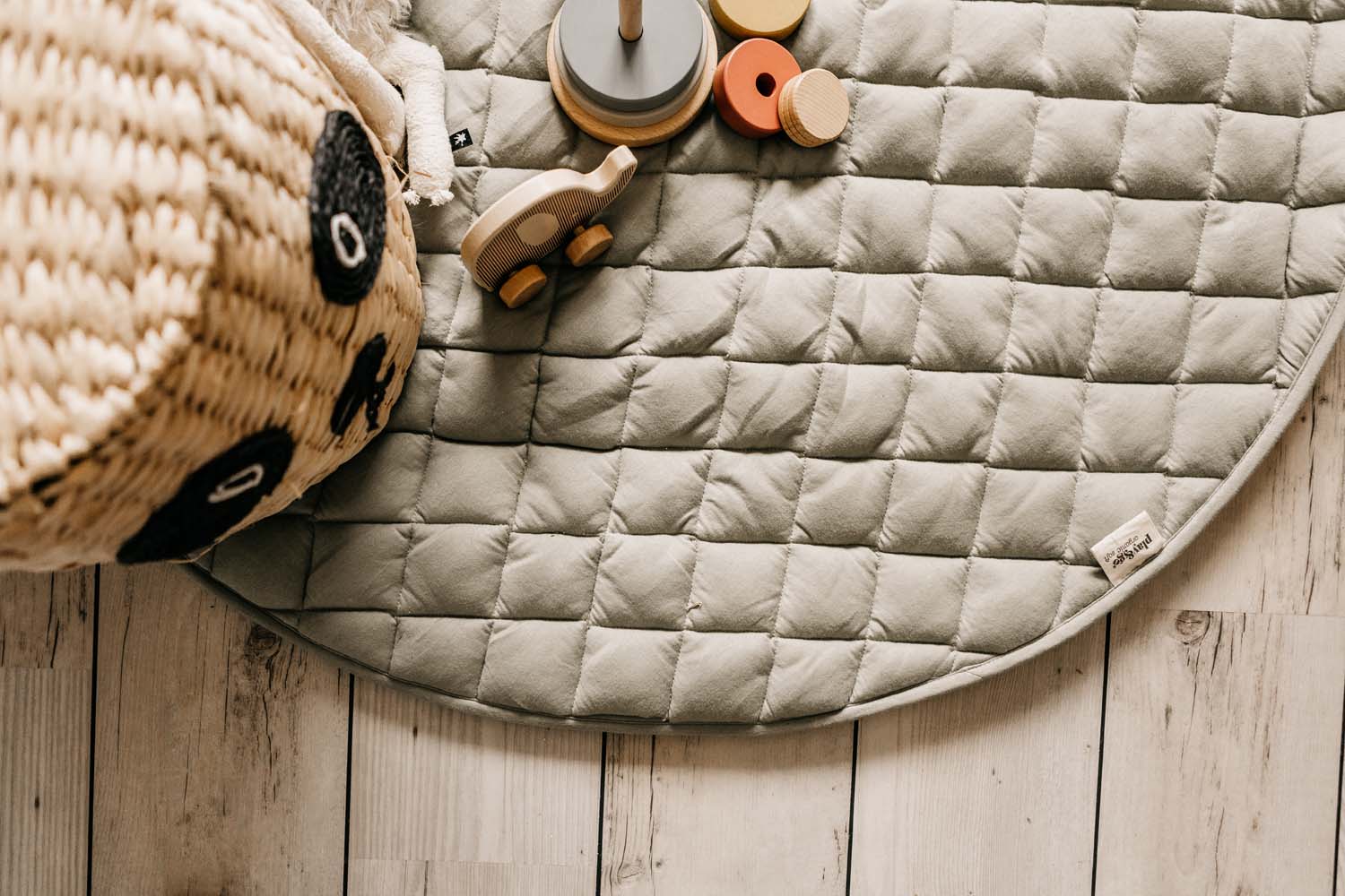 Meadow Green quilted baby play mat and storage bag, mat open of floor, wooden toys