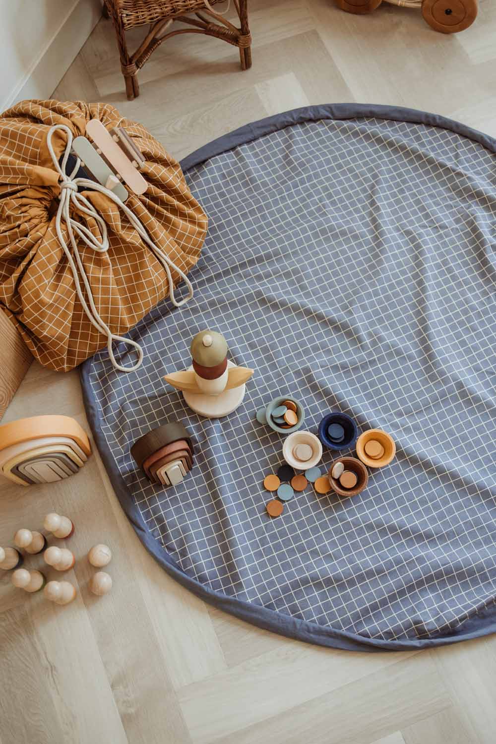 organic storage bag grid blue, open bag on floor, wooden toys, closed bag, grid mustard