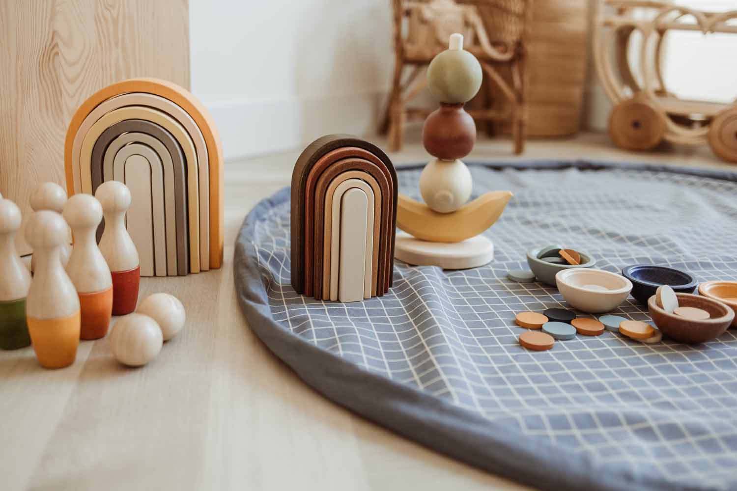 open organic grid blue storage bag, on floor, wooden toys, fruit pyramid