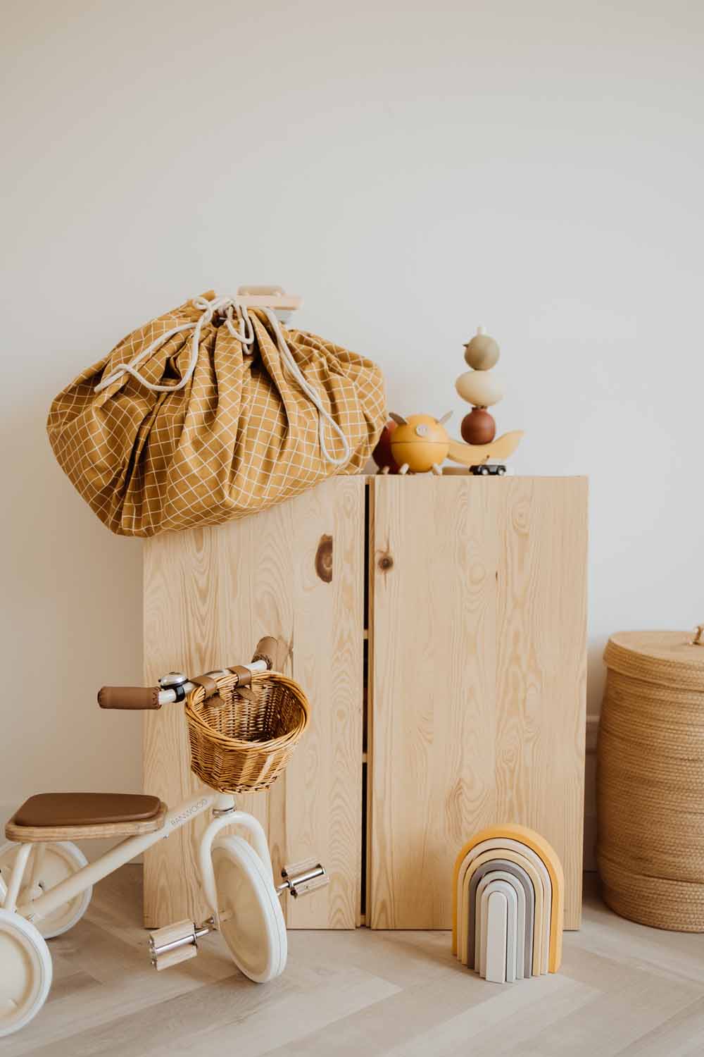 closed organic grid mustard storage bag, wooden closet, tricycle, wooden toys
