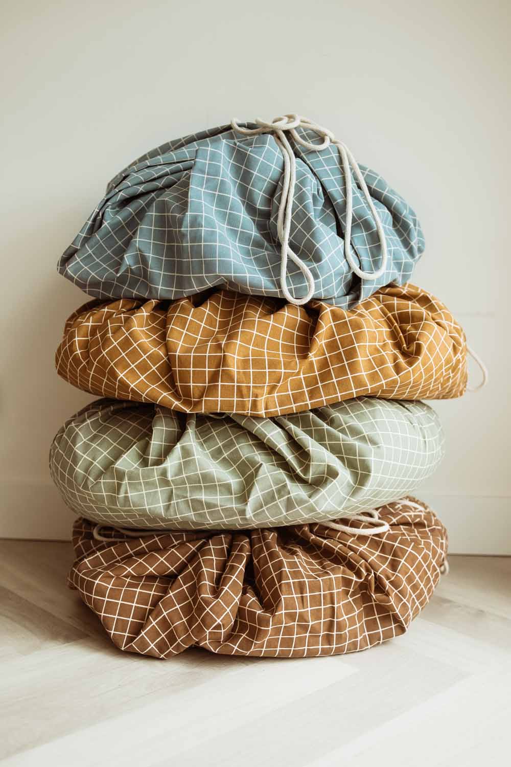 pyramid of grid blue, mustard, green and brown organic storage bags