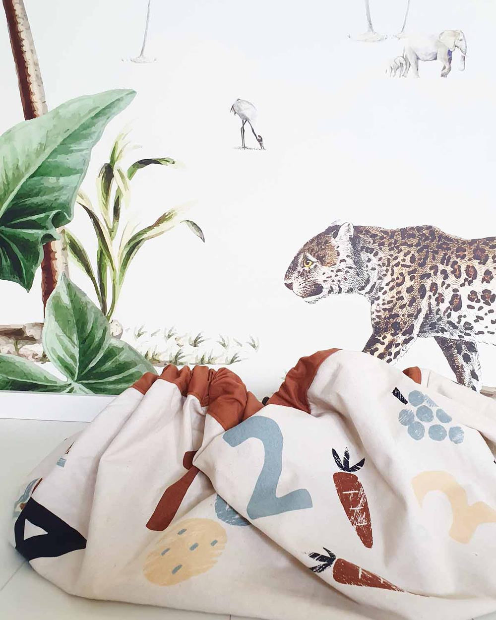 veggie numbers storage bag, closed on floor, tiger wall paper