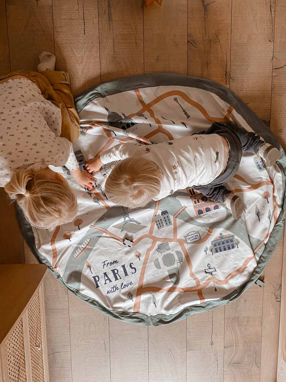 stylish designed Paris Map toy storage bag, picture taken from above, children playing on the mat on the floor