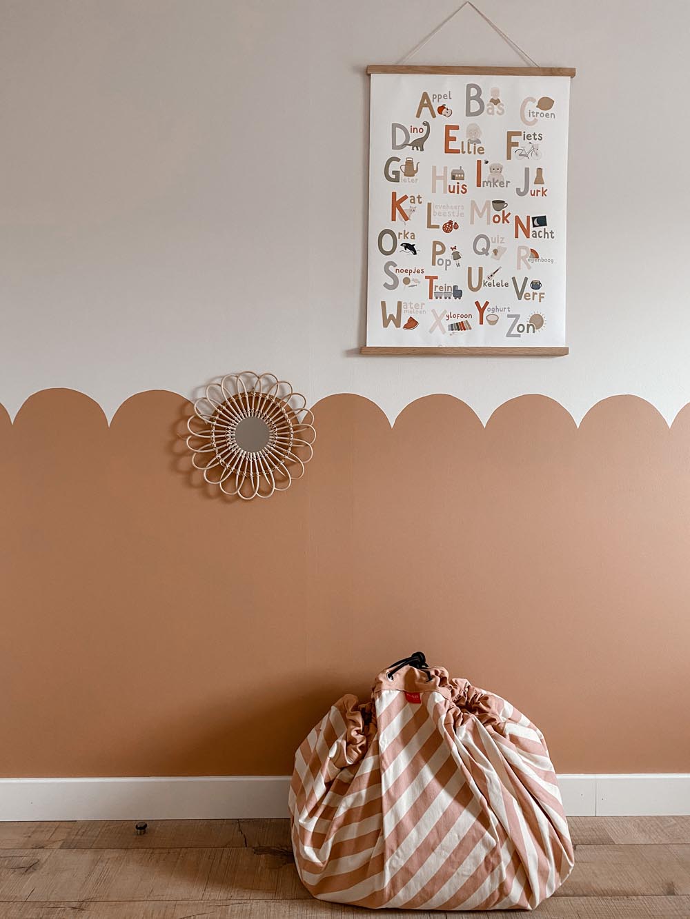 stripes pink new storage bag, closed on floor, a poster of the alphabet on wall