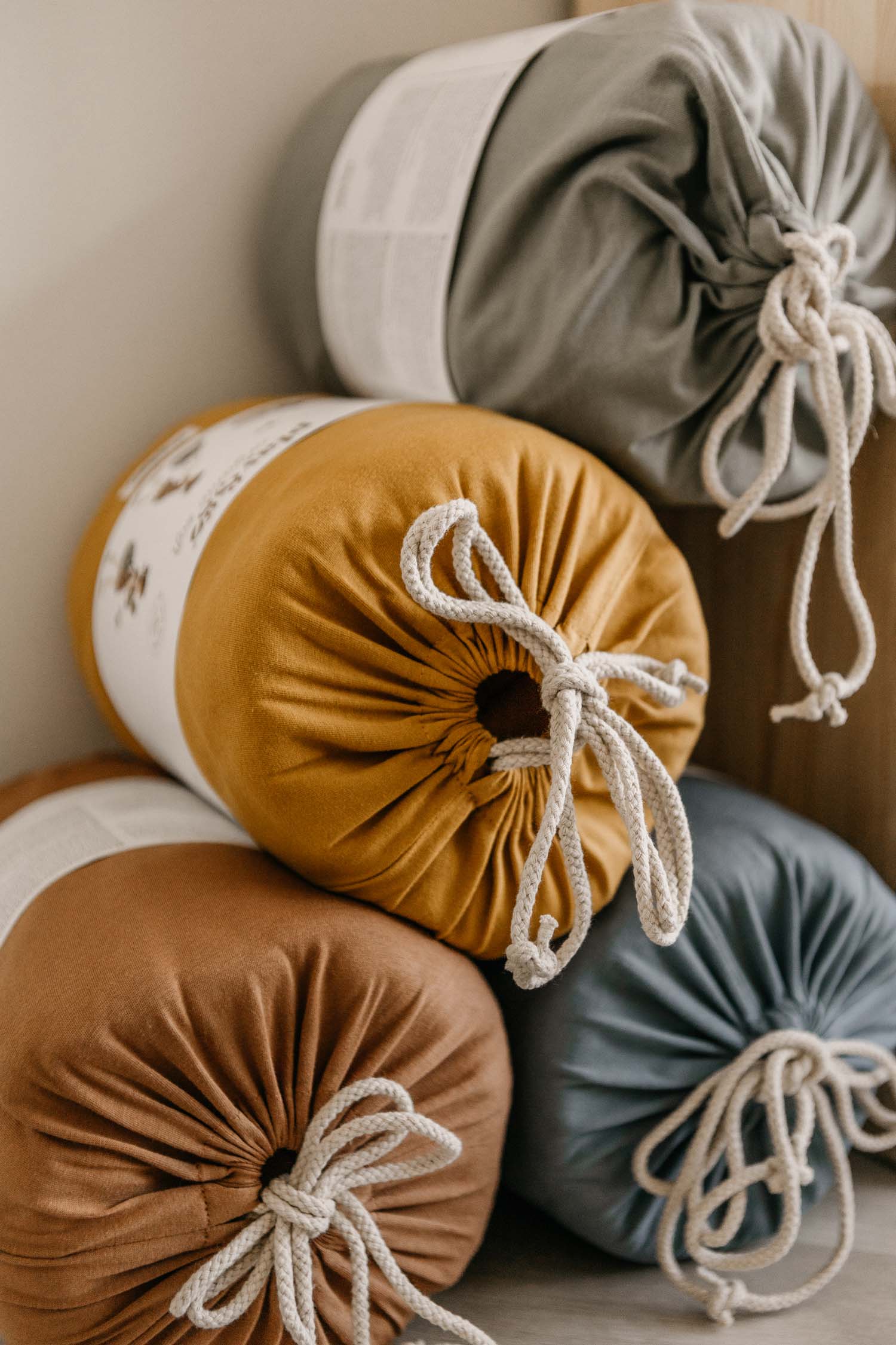 detail picture of the 4 colors of the organic soft padded baby play mats, closed bags in packaging