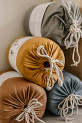 detail picture of the 4 colors of the organic soft padded baby play mats, closed bags in packaging